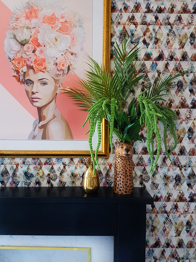 dining room with peach artwork and faux greenery in leopard vase