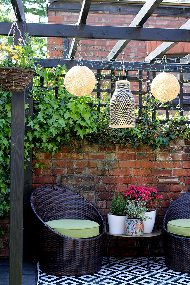 black pergola with bamboo lighting