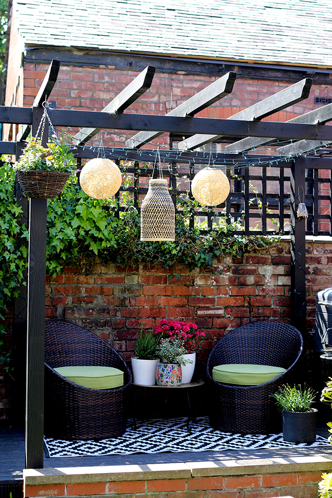 black pergola with bamboo lighting