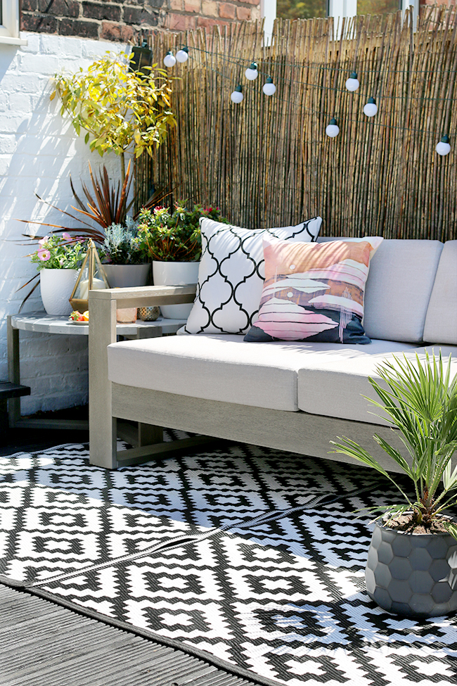 garden patio design with grey sofa and gold accents