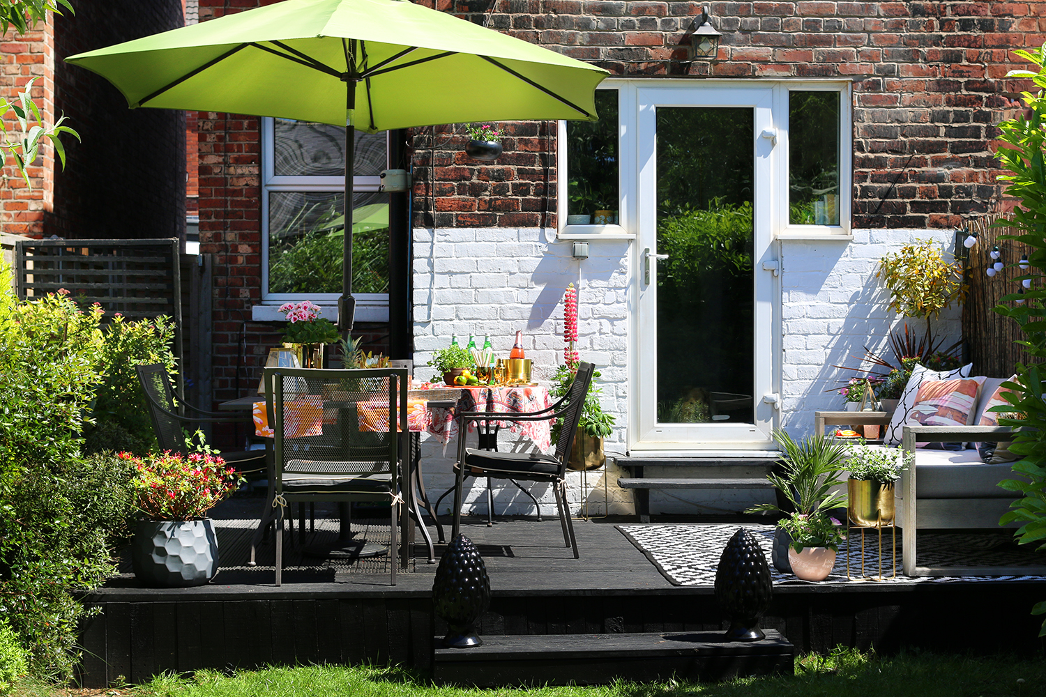 garden patio design with grey sofa and gold accents