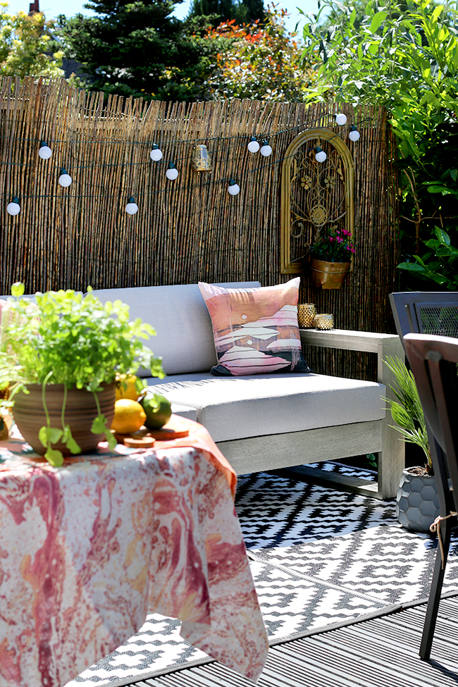 garden patio design with grey sofa and gold accents