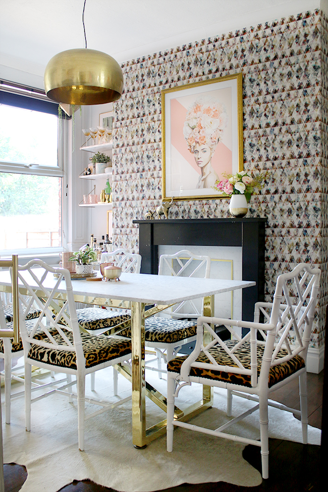 dining room with marble table and brass base with faux bamboo chairs