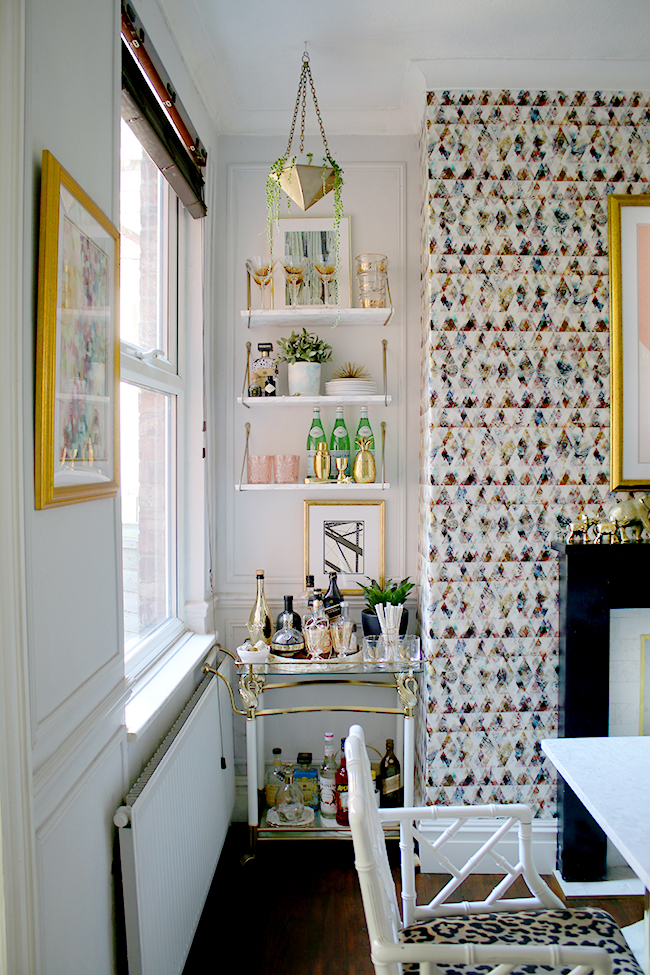 bar cart with marble shelves and hanging planter