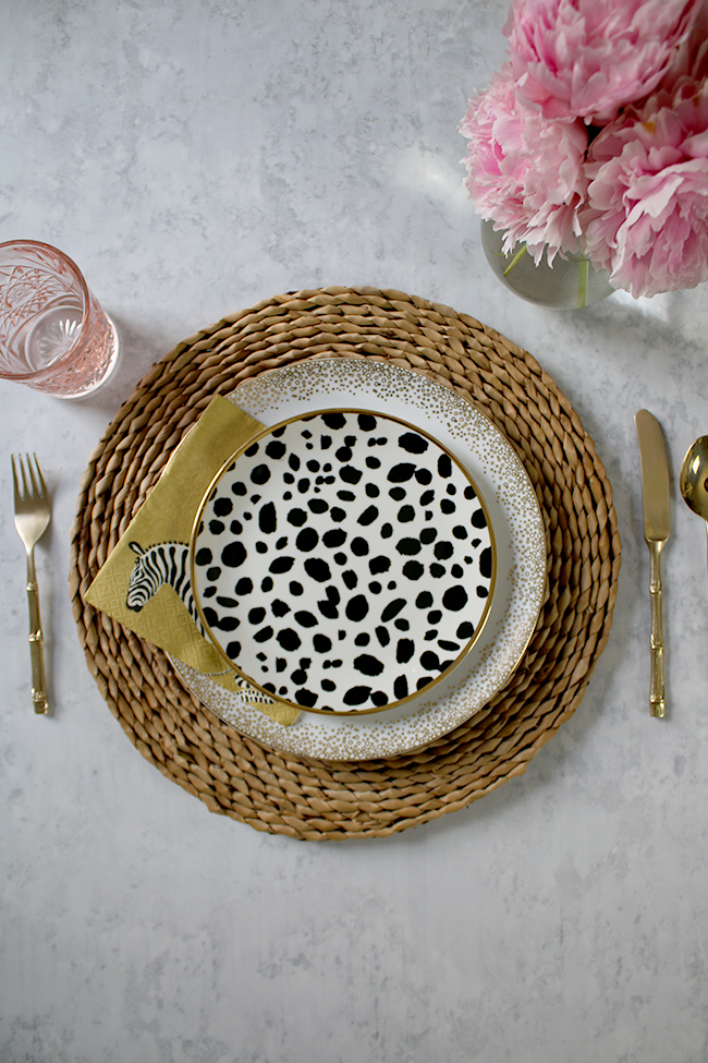 table setting mix and match natural and black and white polkadots with pink accents