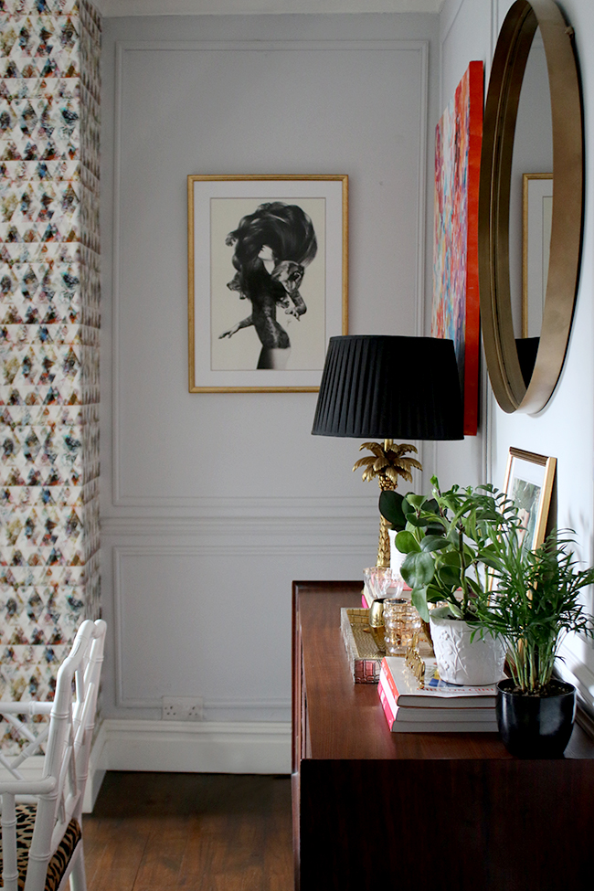 dining room with vintage sideboard and art