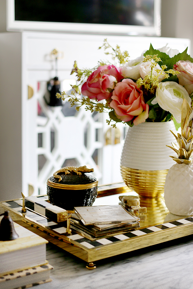 L'Objet Crocodile Scented Candle on black and white and gold tray with flowers on coffee table