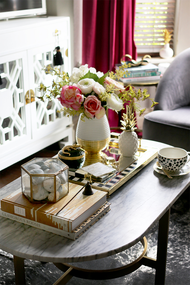 L'Objet Crocodile Scented Candle on black and white and gold tray with flowers on coffee table