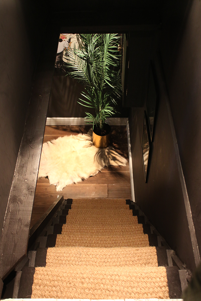 black stairs with coir runner