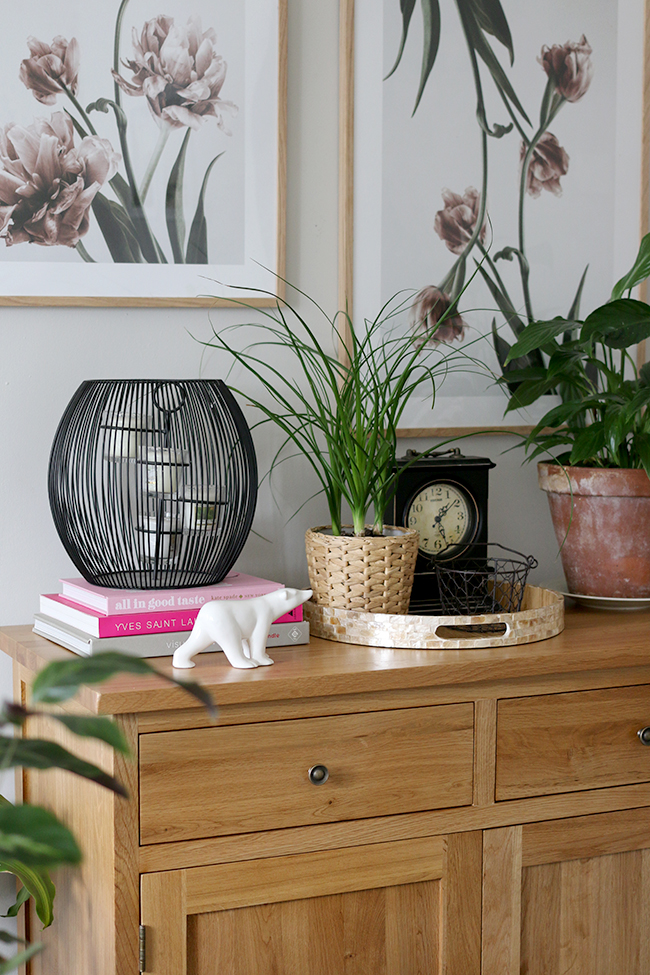 Wooden sideboard with artwork adds the finishing touch to the contemporary romantic living room