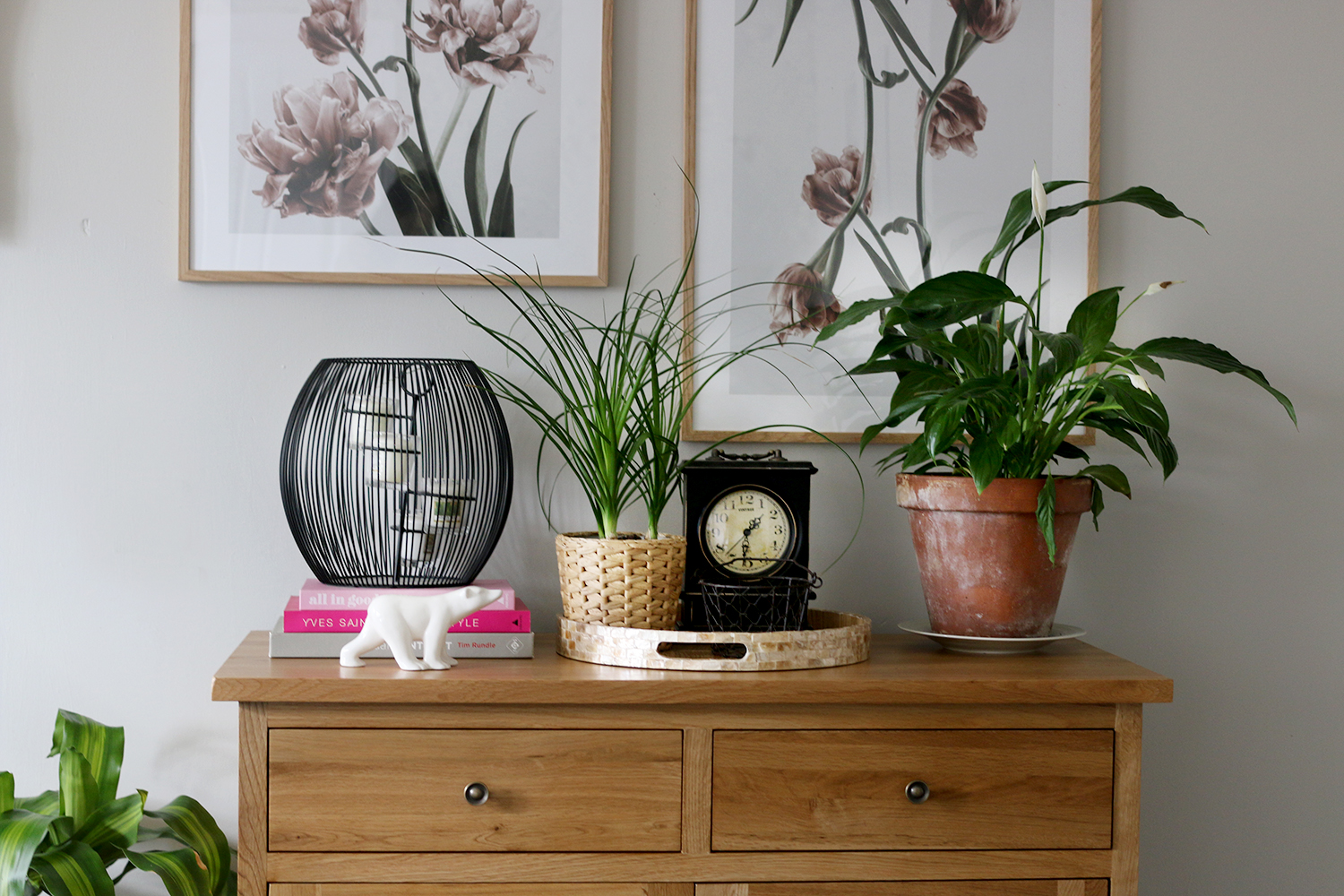 Wooden sideboard with artwork in a contemporary romantic living room