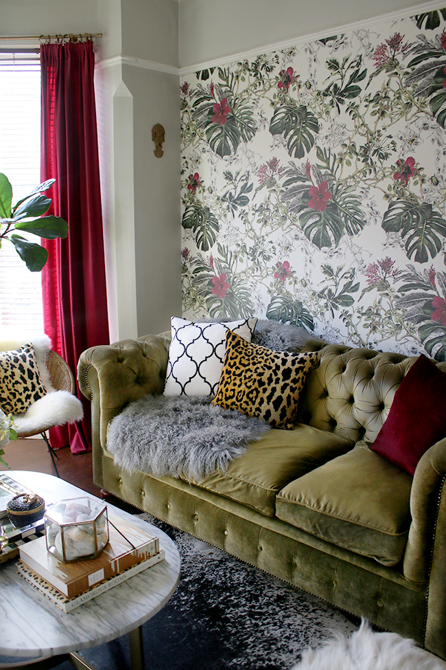 green velvet chesterfield sofa with grey mongolian throw and leopard print cushion