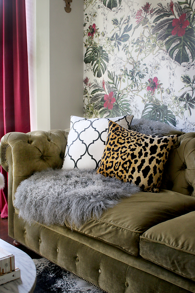 green velvet chesterfield sofa with grey mongolian throw and leopard print cushion