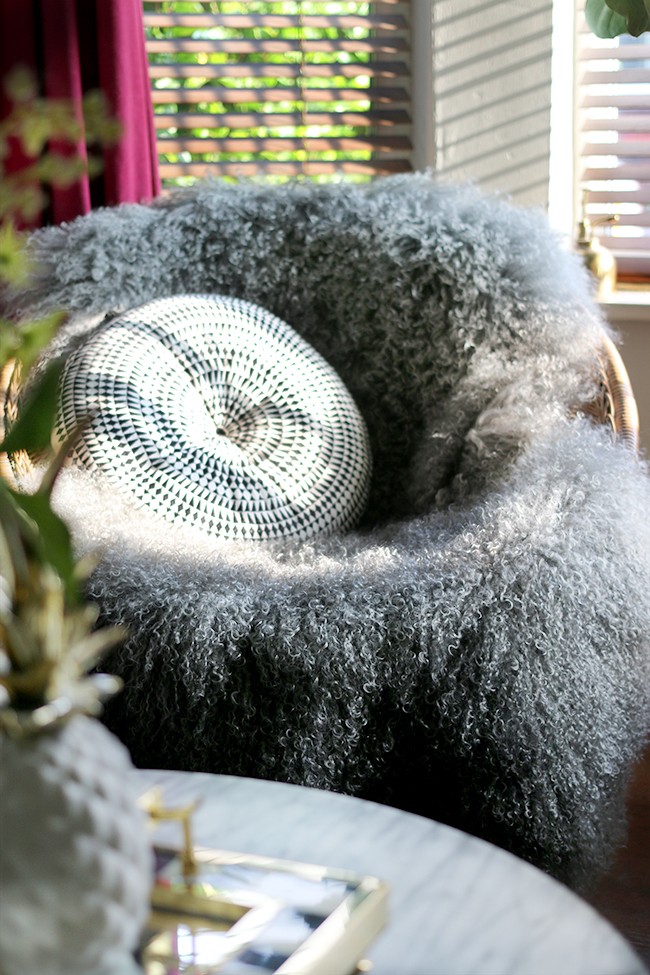 vintage rattan hoop chair with grey mongolian sheep skin throw