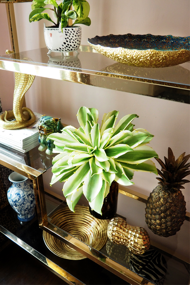 Brass and glass vintage shelving unit in pink office