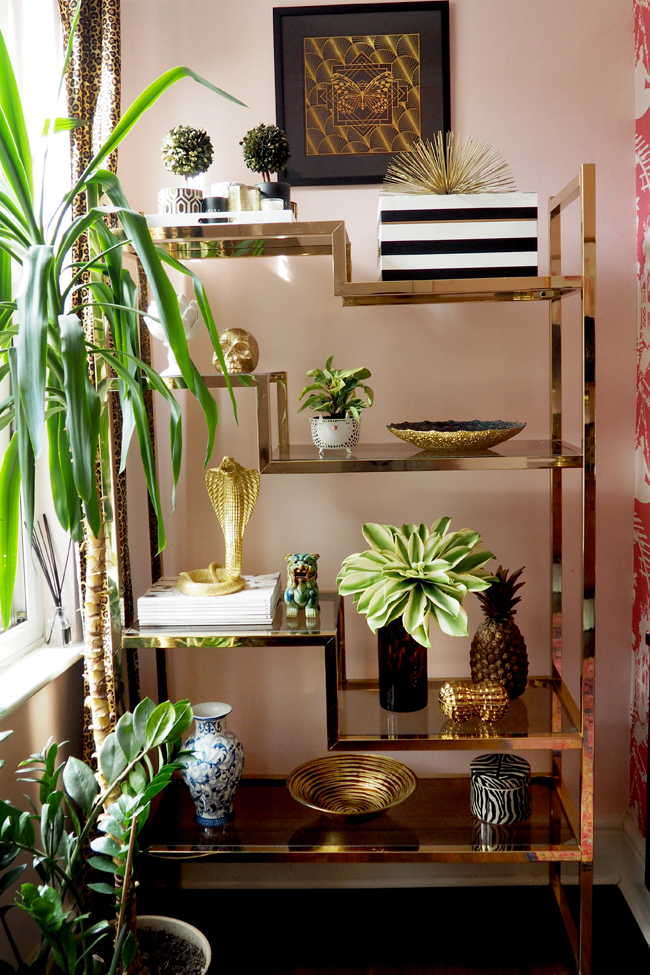 Brass and glass vintage shelving unit in pink office