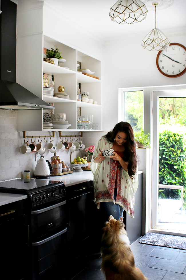 Kimberly Swoon Worthy and her Sheltie Quito in the kitchen