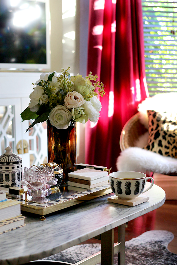 coffee table styling with leopard print and burgundy curtains