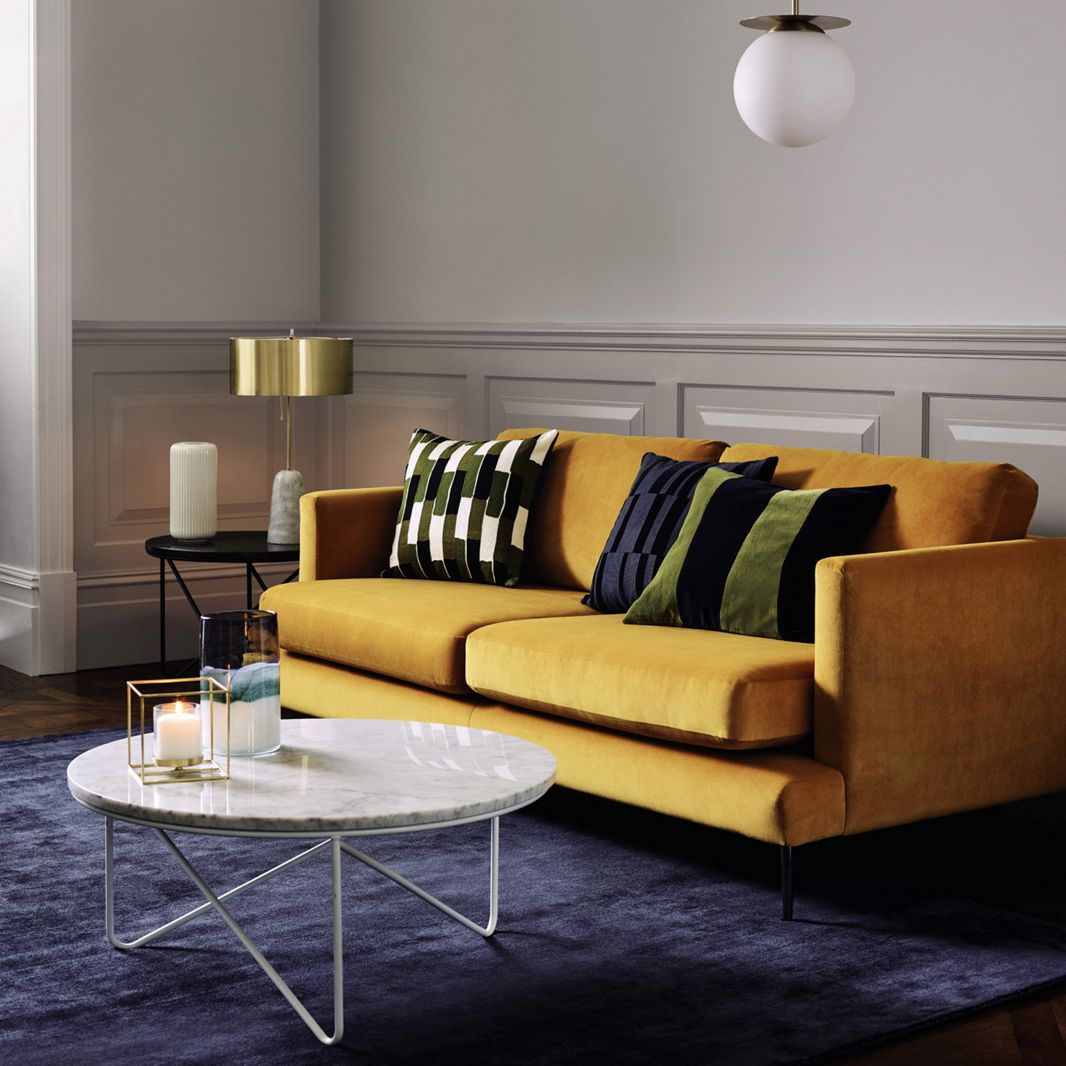 mustard sofa with gold table lamp from Debenhams