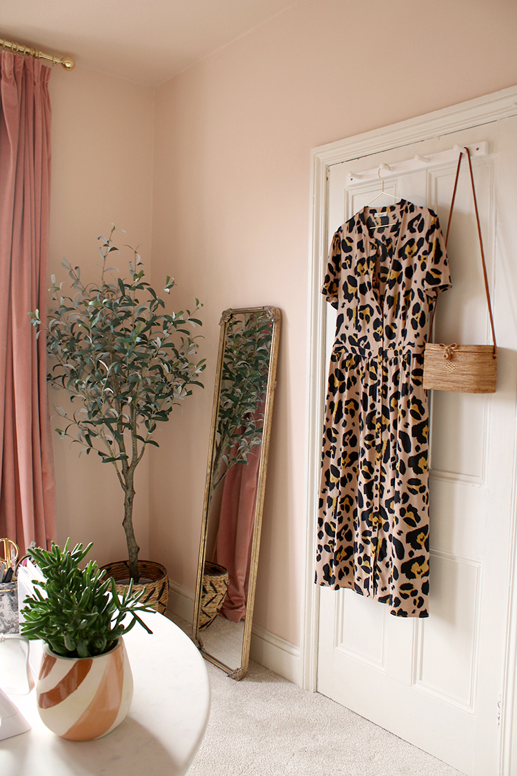 dressing room in peach with floor mirror and olive tree in corner